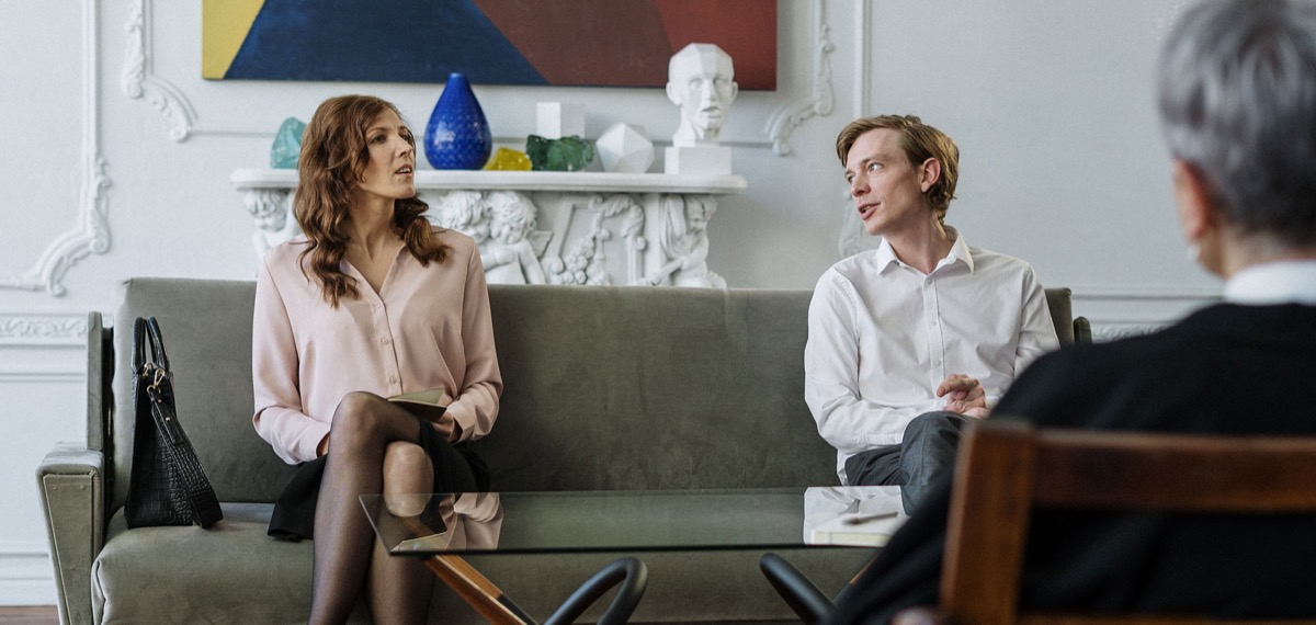 A couple talks with their therapist during a counseling session